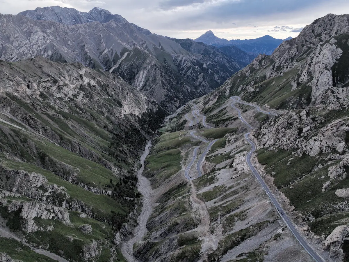 Mountain highway winding through Tianshan scenery in Xinjiang