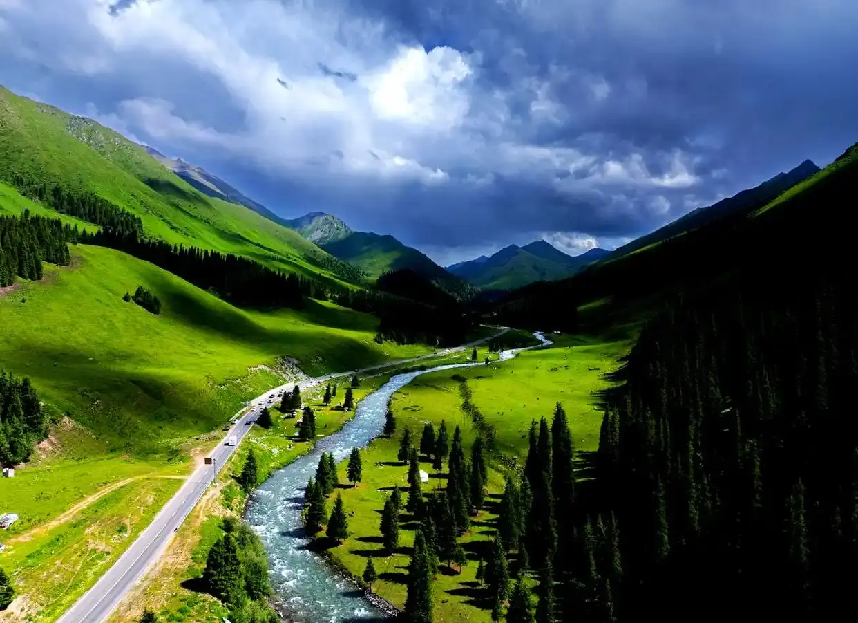 Mountain highway through the Tianshan range in Xinjiang, typical of long-distance coach routes