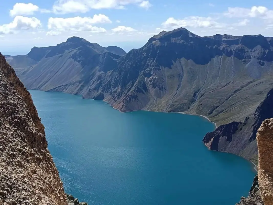 Heavenly Lake, or Tianchi, a mountain lake ringed by conifer forest and snowy Tianshan peaks near Urumqi in Xinjiang
