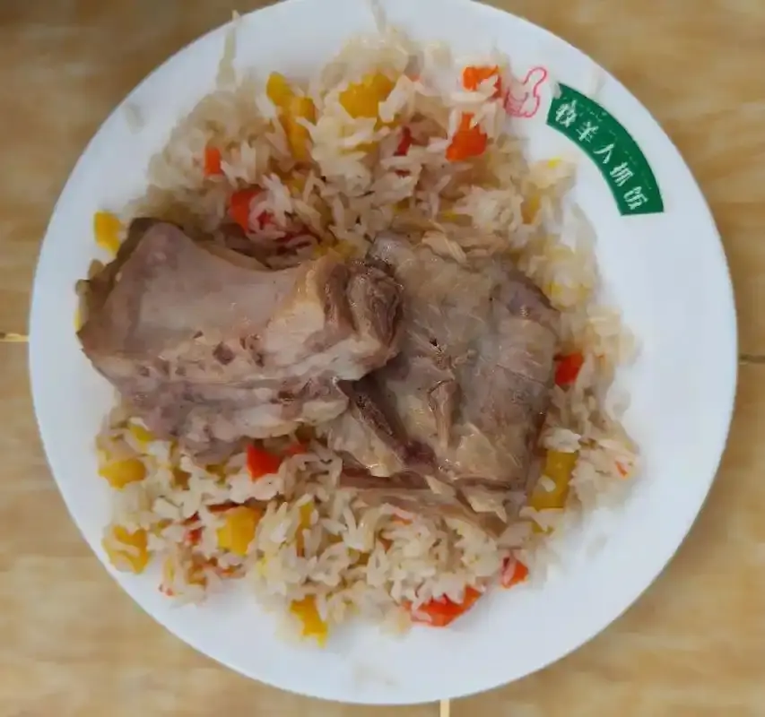 A plate of Xinjiang polo rice with lamb