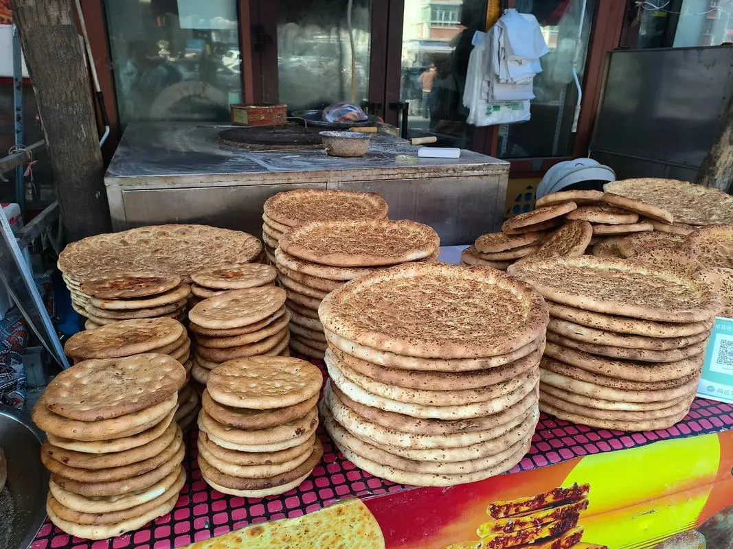 Fresh Xinjiang naan flatbread, a naturally vegan staple baked in a tonur oven