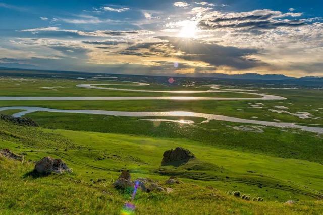 Spruce forest, stream and snow-capped Tianshan along the Jiangbulake scenic loop