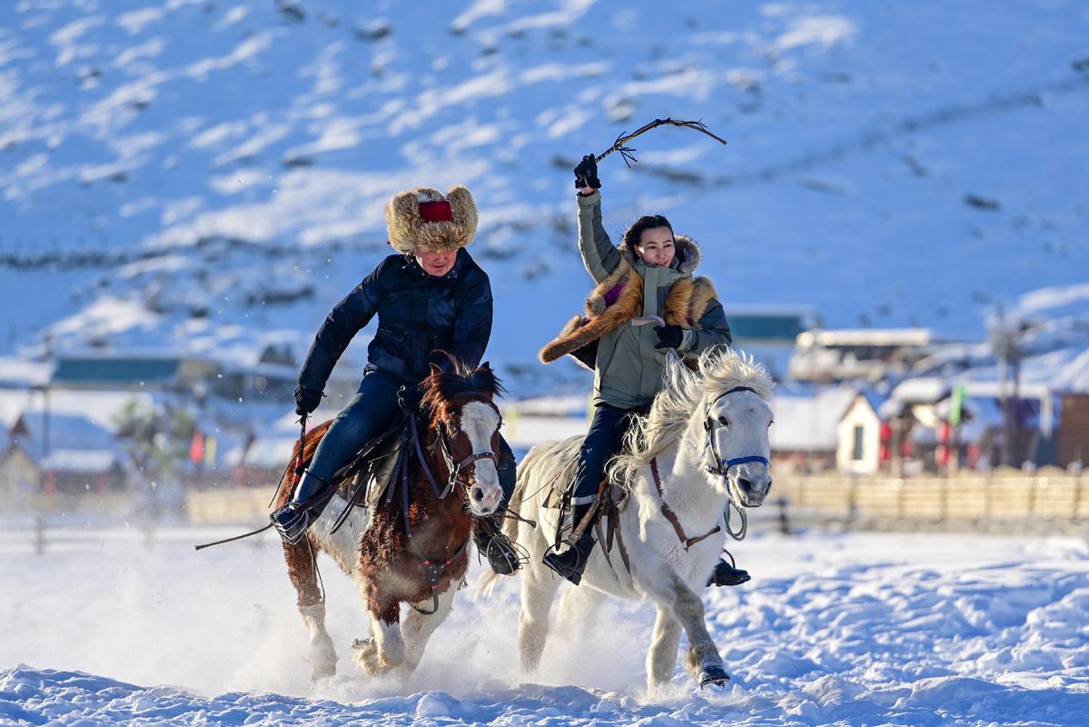 Horsemen crossing snowy pasture in Bortala, northern Xinjiang